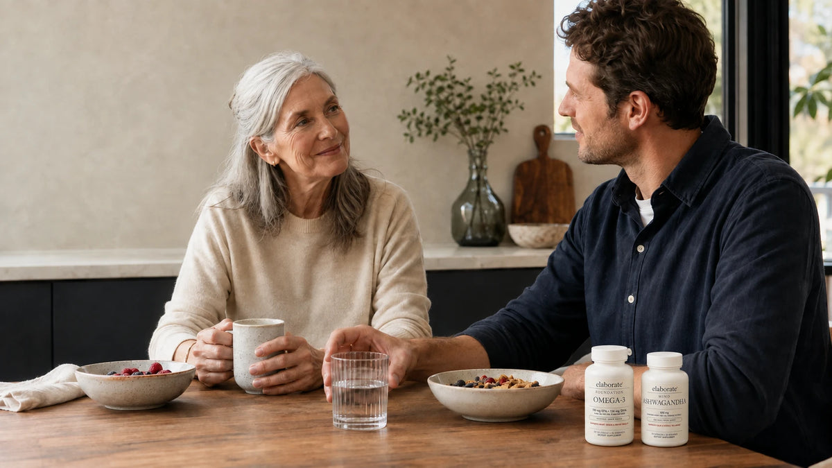 Two generations at breakfast table with Elaborate Foundation Omega-3 and Mind Ashwagandha bottles